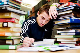 Student studying for the K53 learner's licence test surrounded by books